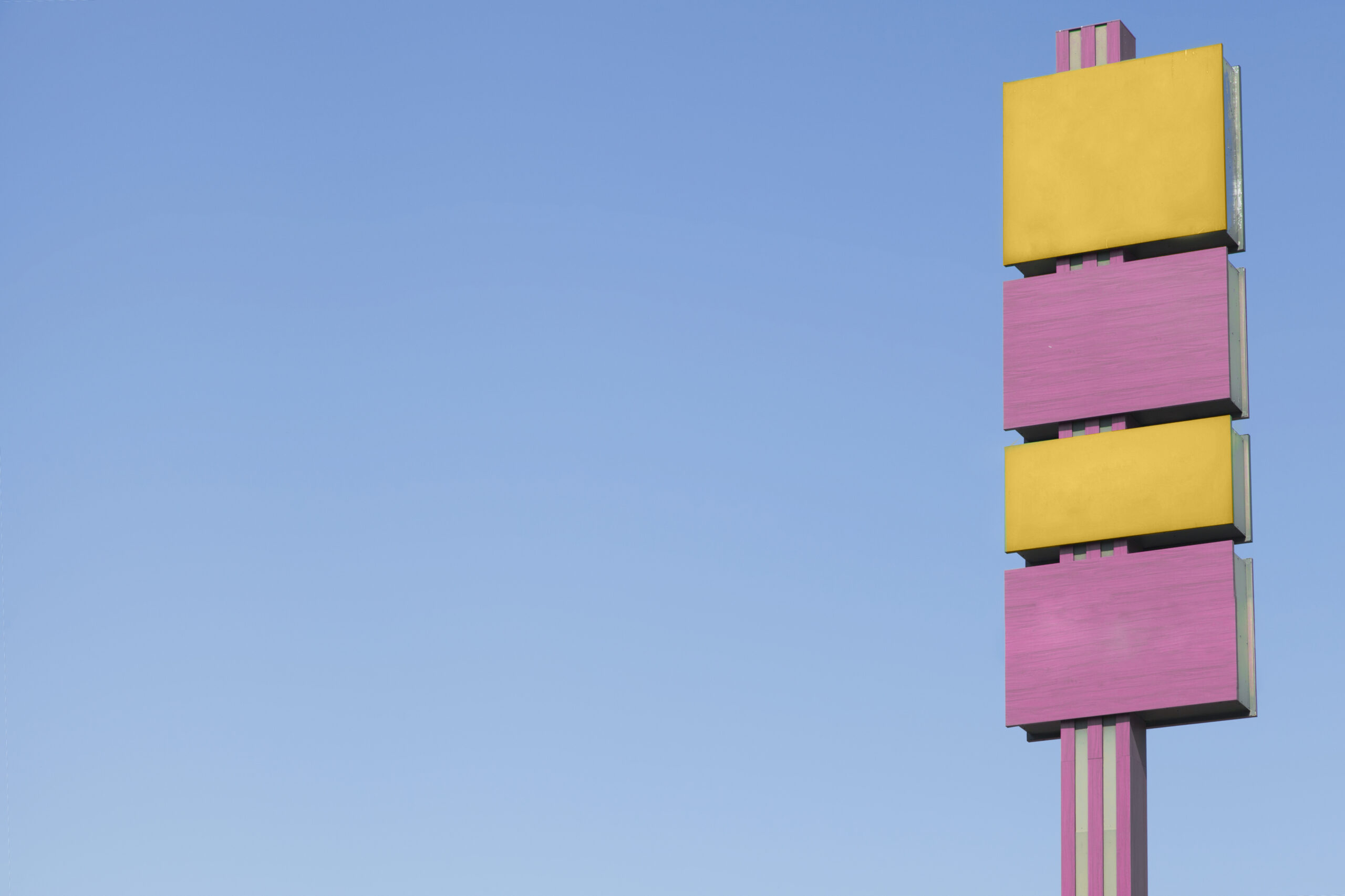 yellow-pink-billboards-against-blue-sky